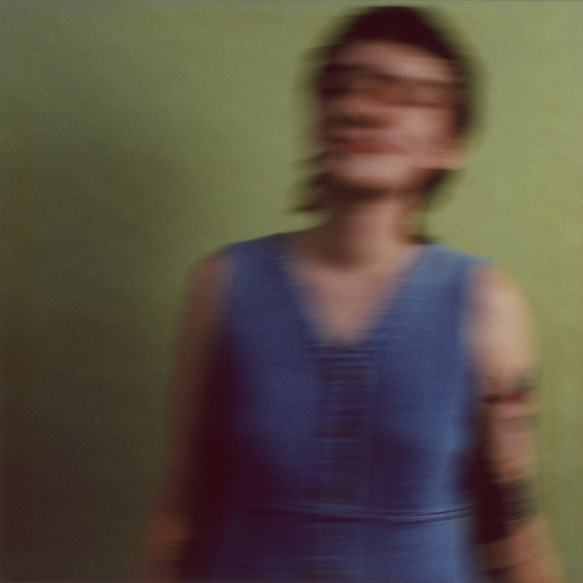 cover of Sister Ray's believer album, which is a blurry image of the singer on a green background.